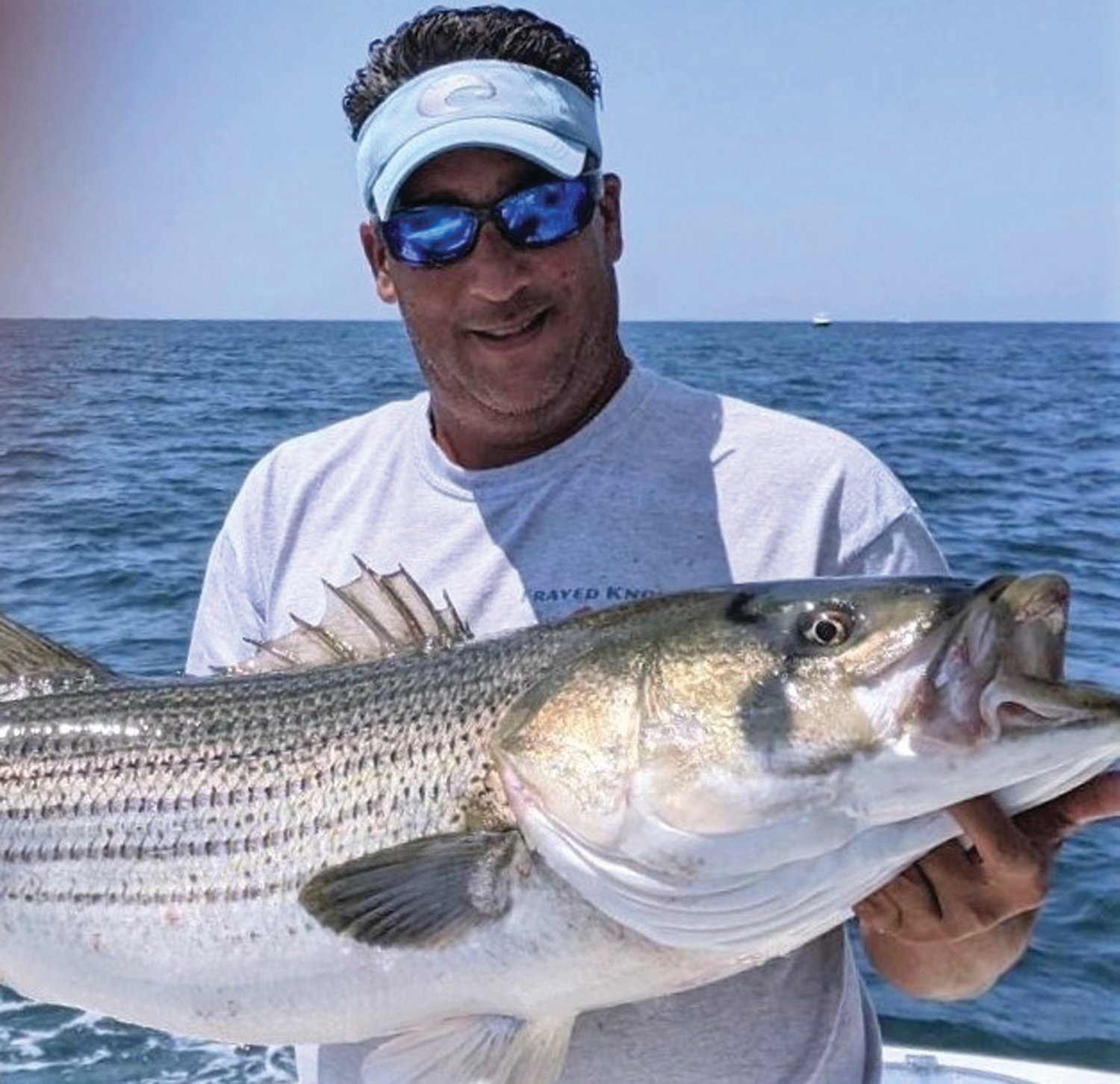 WINNING BASS: Capt. Richard Lipsitz of North Kingstown with the 47.5-inch striped bass that took first place and capped the top “Team” award for team Frayed Knot in the Block Island Inshore Fishing Tournament last year.